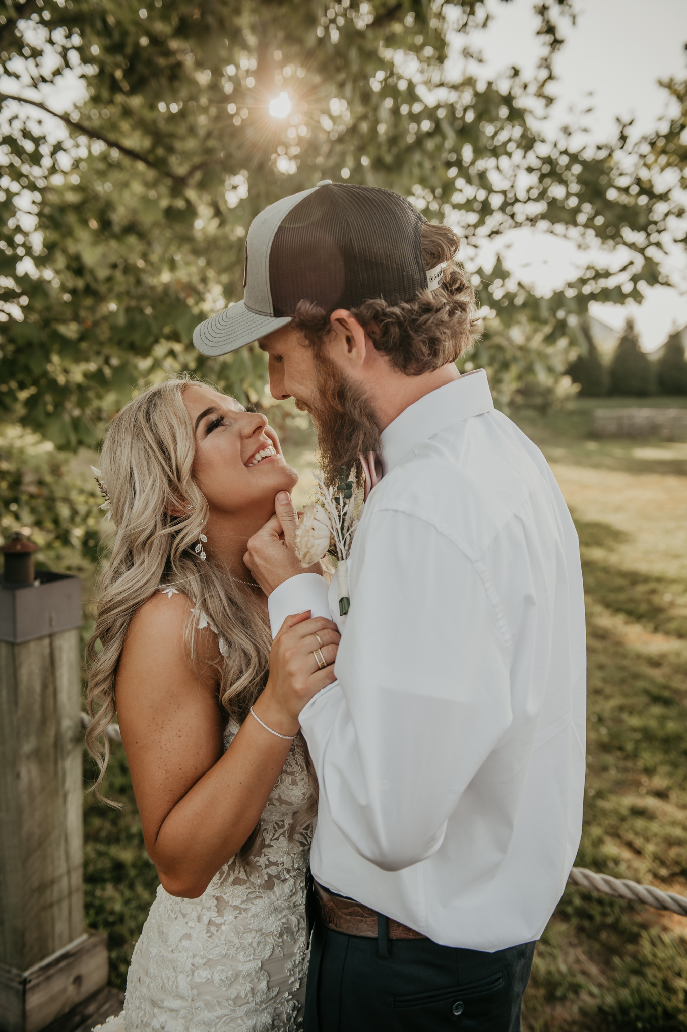 Hali & Kyle share a close golden-hour portrait outdoors at Covey Creek, his hand gently under her chin.