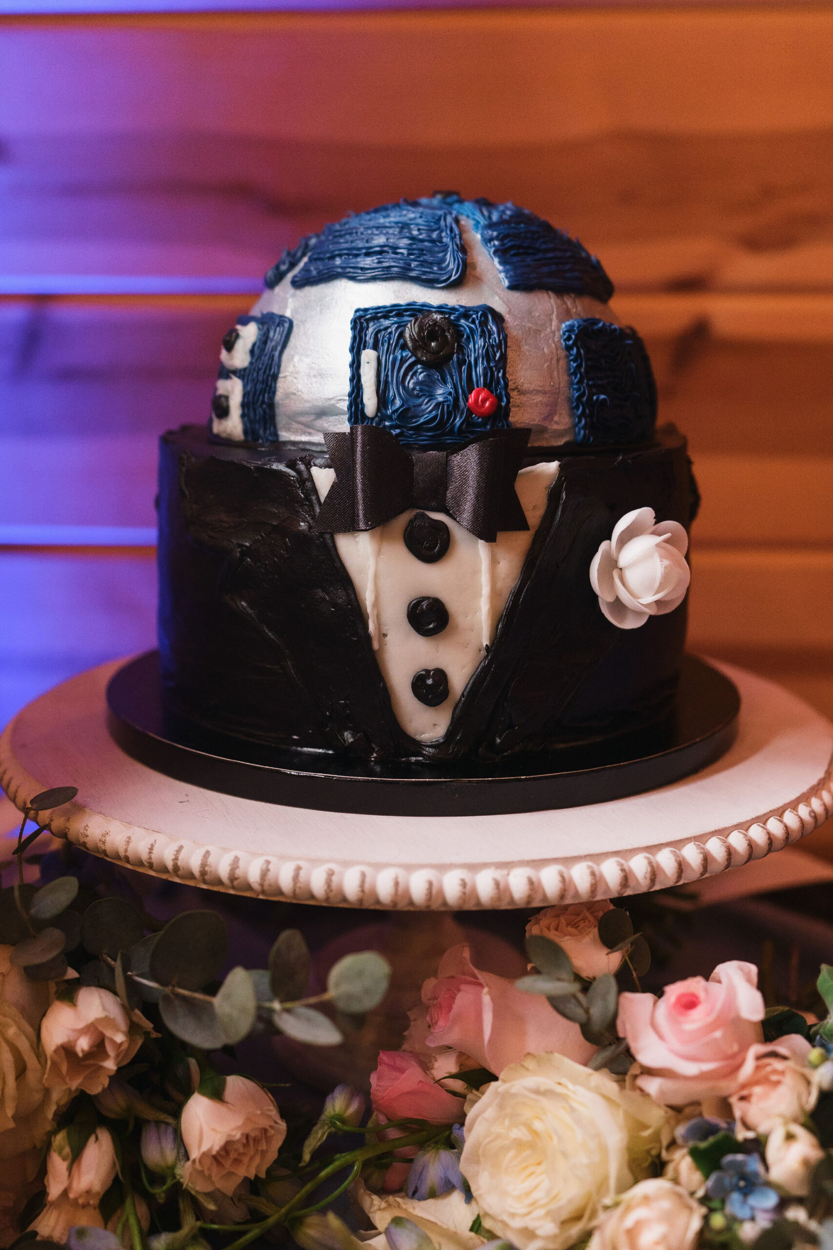 Ana & Carter Star Wars R2-D2 tuxedo groom's cake with pink roses on a pedestal at Covey Creek