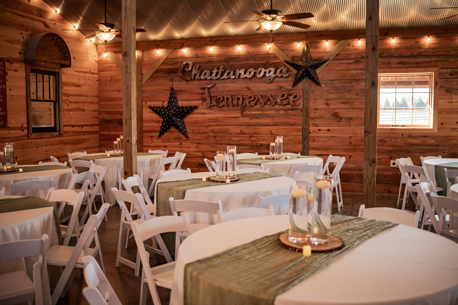 Chattanooga Tennessee wood sign and floating-candle tables fill Covey Creek’s reception hall for Annie & Will’s wedding.