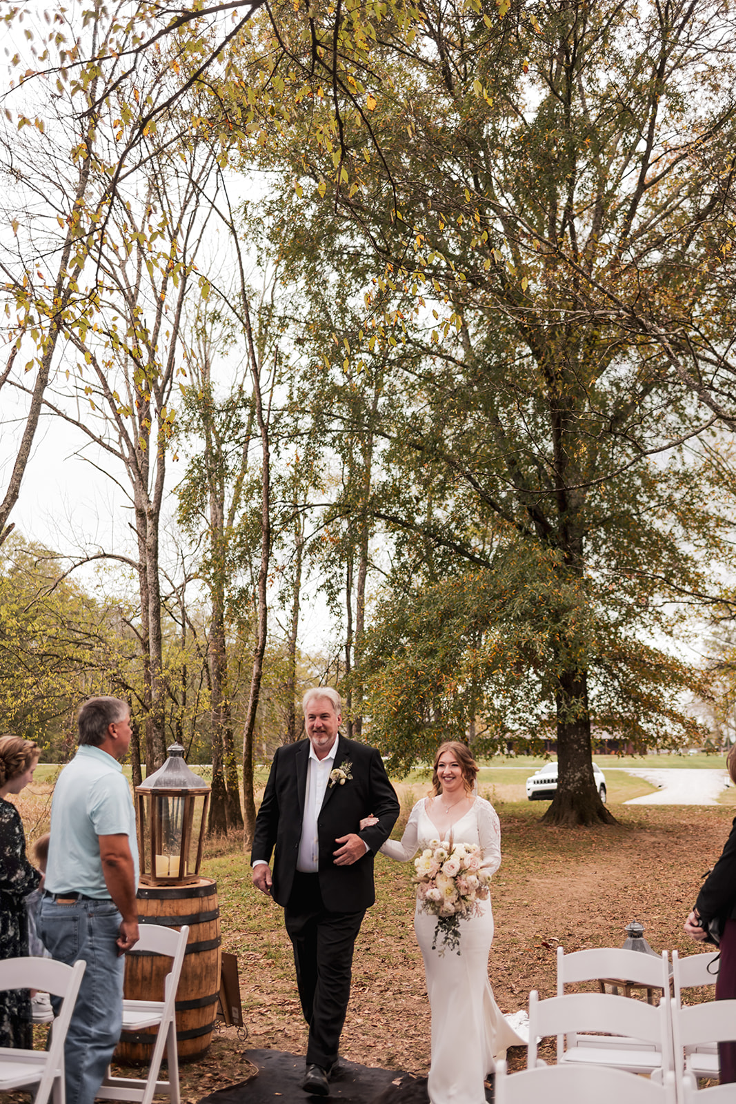 Isabelle walks the Covey Creek Tunnel of Love aisle with her father at Isabelle & Alex’s fall wedding.