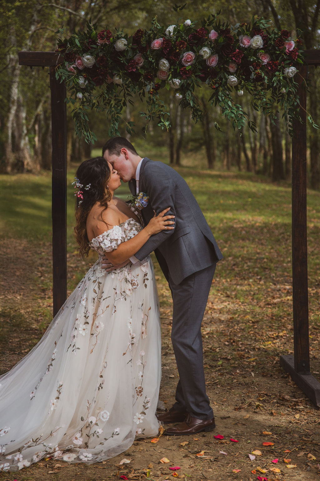 Jen & Alec share their first kiss under a rose-covered arbor in the Tunnel of Love at Covey Creek