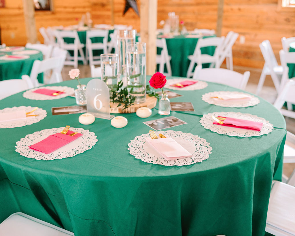 Kate & Josh Covey Creek reception table: emerald linens, pink napkins, wood-slice centerpiece, table 6
