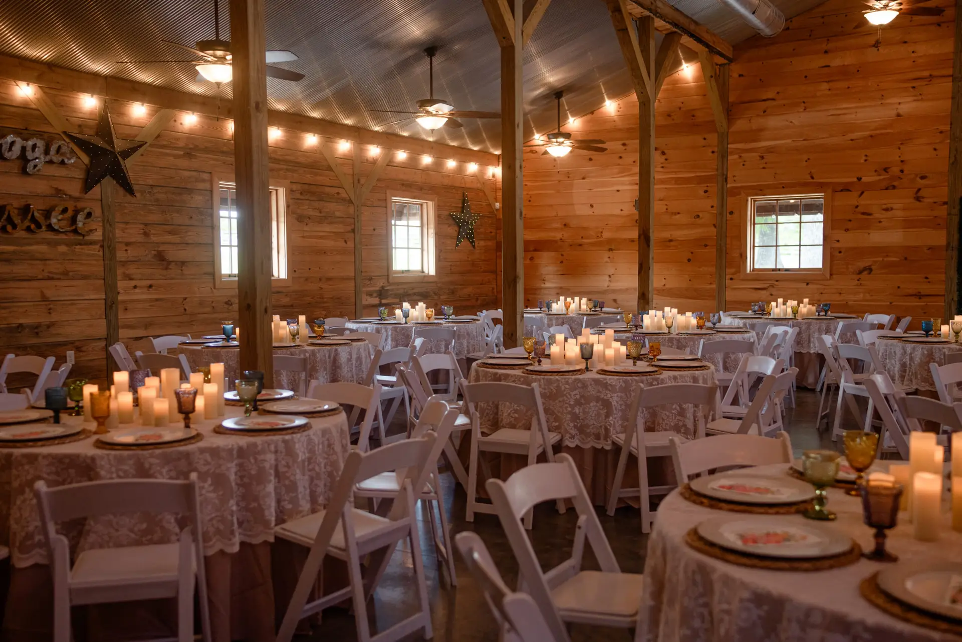 Lace-covered reception tables with candles and vintage glassware for Rachael & Ben at Covey Creek.