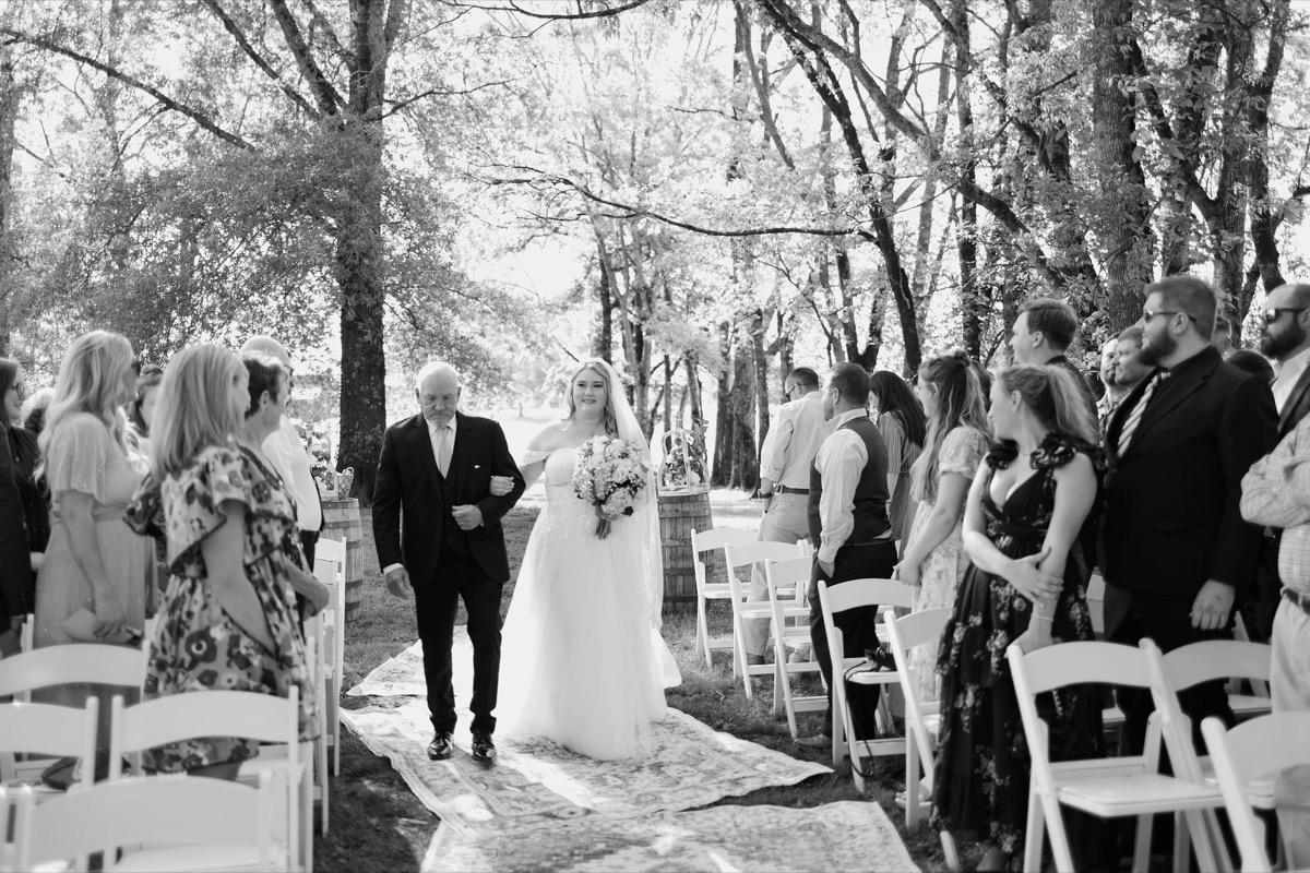 Carly processes down the Tunnel of Love aisle with her father at Covey Creek for Carly & Lucas wedding