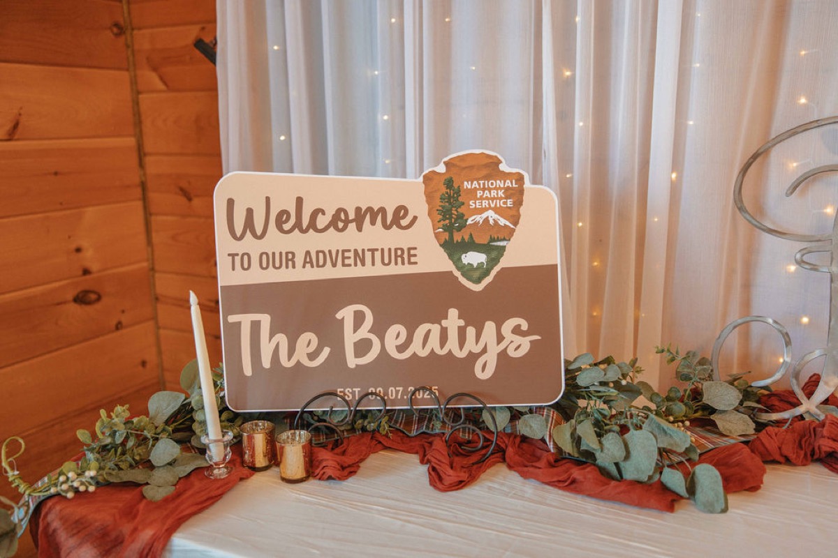 Claire & Jacob National Park welcome sign for The Beatys with eucalyptus and candles at Covey Creek