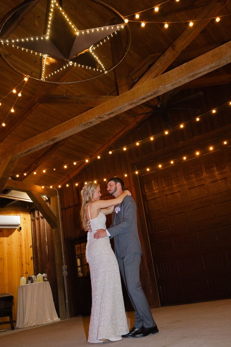 Courtney & Brett share a first dance under the glowing star and string lights at Covey Creek