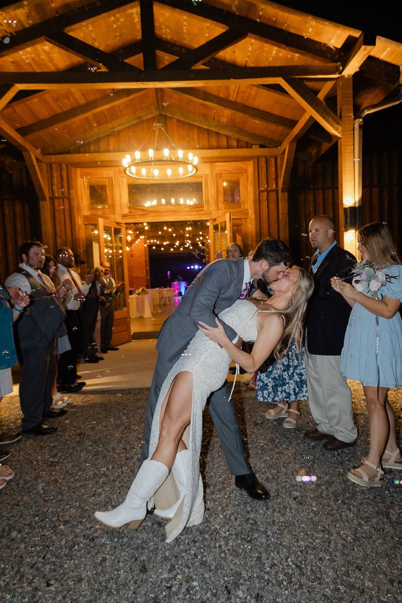 Courtney & Brett share a night dip kiss amid floating bubbles outside Covey Creek barn doors