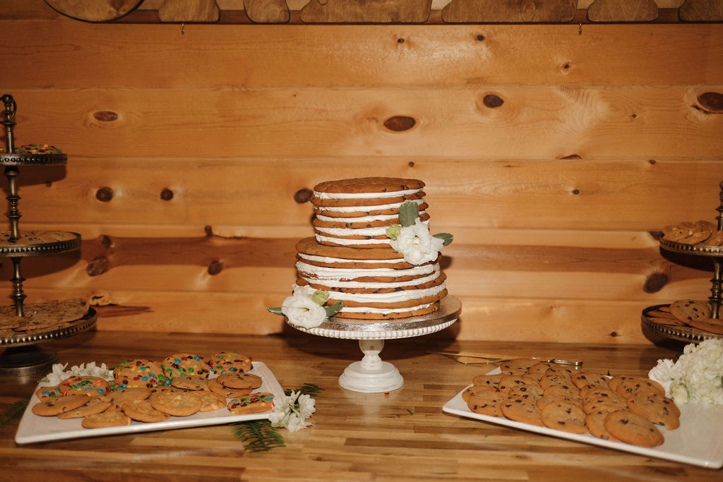 Stacked cookie wedding cake and cookie platters on the dessert table at Hailey & Joseph's Covey Creek wedding