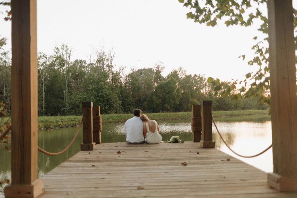 Hailey rests her head on Joseph's shoulder at the Pond dock during Hailey & Joseph portraits at Covey Creek
