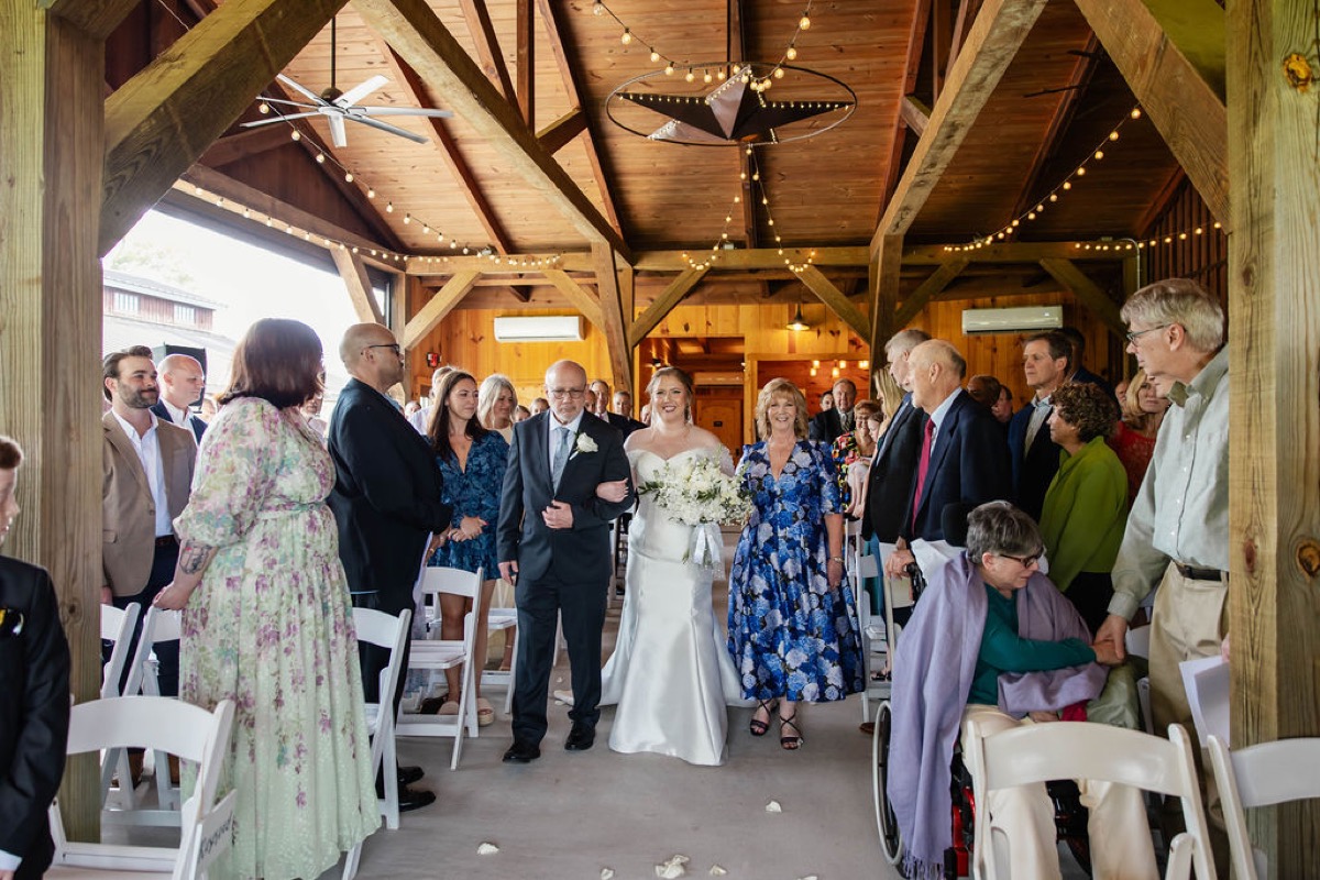 Hannah walks the aisle with her parents under Covey Creek pavilion string lights, Hannah & Nicholas.