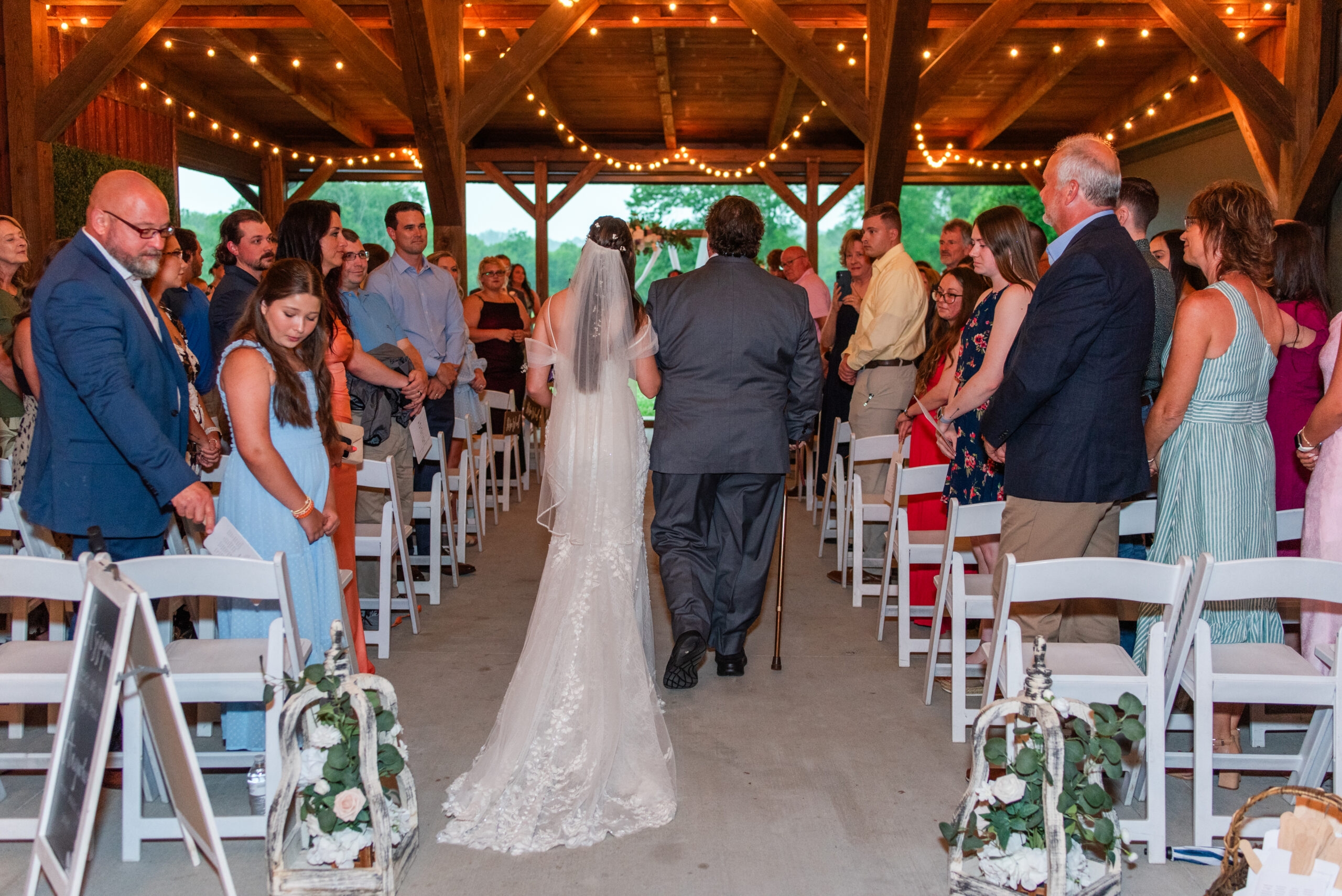 Hannah walks the patio pavilion aisle with her father for her wedding to Ryan at Covey Creek.