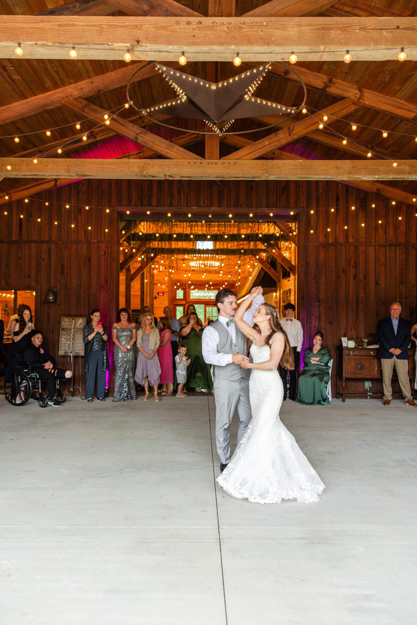 Hannah & Ryan share their first dance under Edison lights and a star in the barn at Covey Creek.