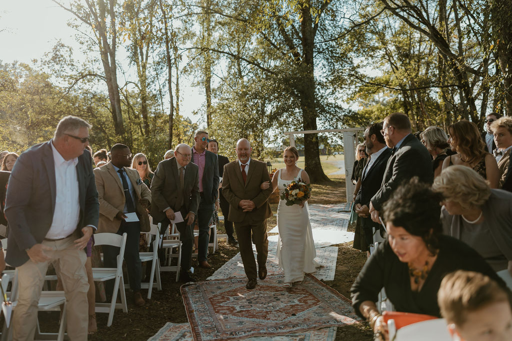 JJ & Will: JJ walks the Tunnel of Love rug aisle arm-in-arm with her father at Covey Creek
