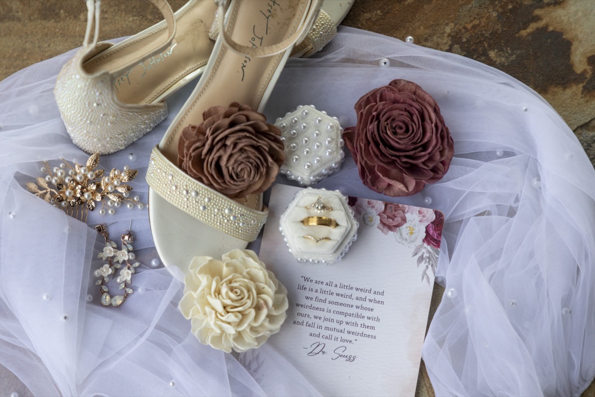 Kristen & Dalton flat lay of pearl Betsey Johnson sandals, velvet ring boxes, and sola blooms at Covey Creek