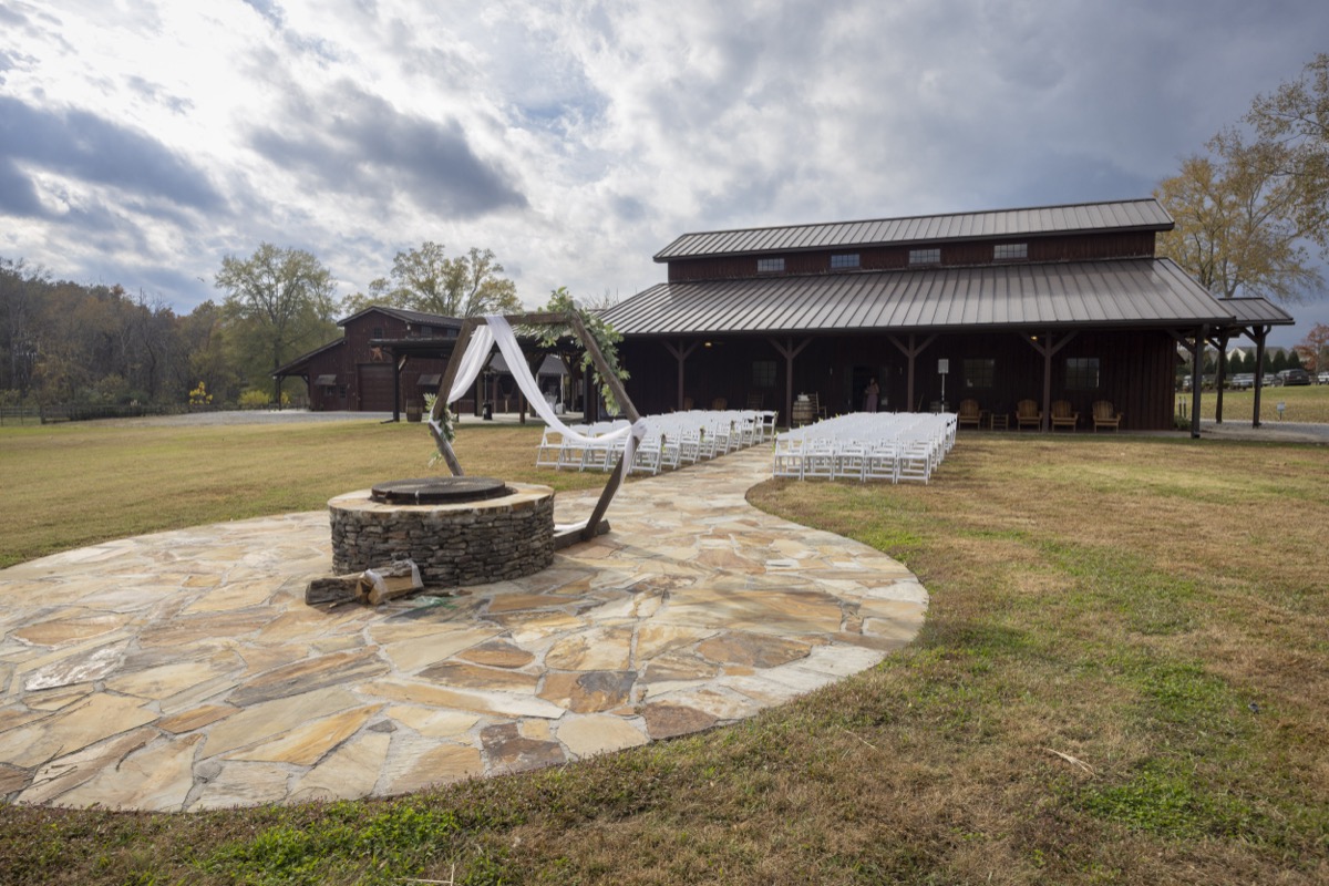 Kristen & Dalton hexagonal arbor at the Firepit, white chairs lining the flagstone path toward the Covey Creek barn