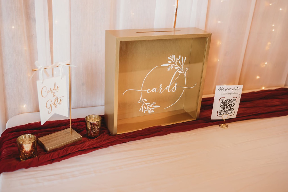 Gold card box and Cards & Gifts sign on a burgundy runner for Lauren & Alex at Covey Creek