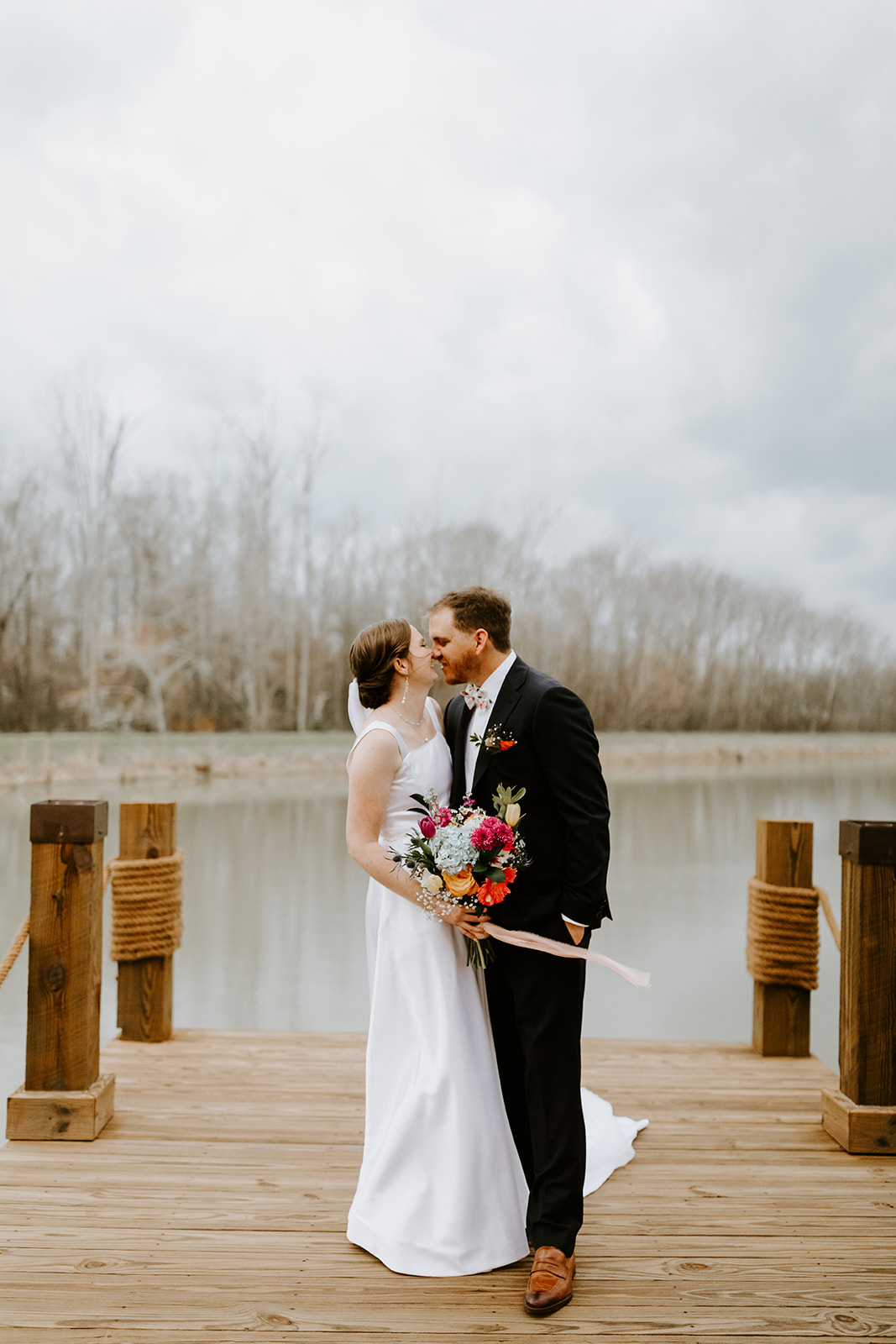 Leslie & Timothy share a near-kiss on the rope-posted wooden dock over the pond at Covey Creek