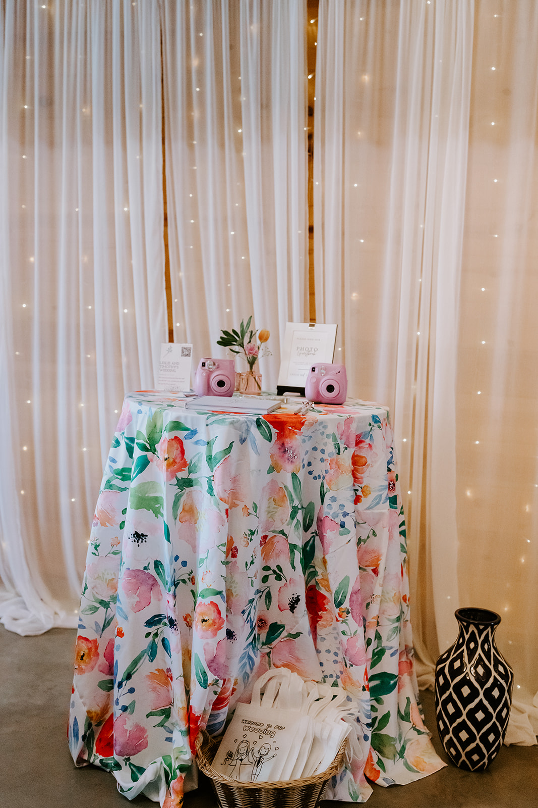 Leslie & Timothy photo guestbook table with Instax cameras and floral cloth at Covey Creek