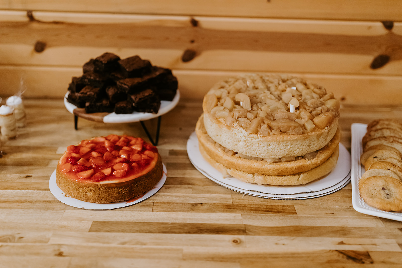 Leslie & Timothy dessert table with strawberry cheesecake, cake, and cookies at Covey Creek