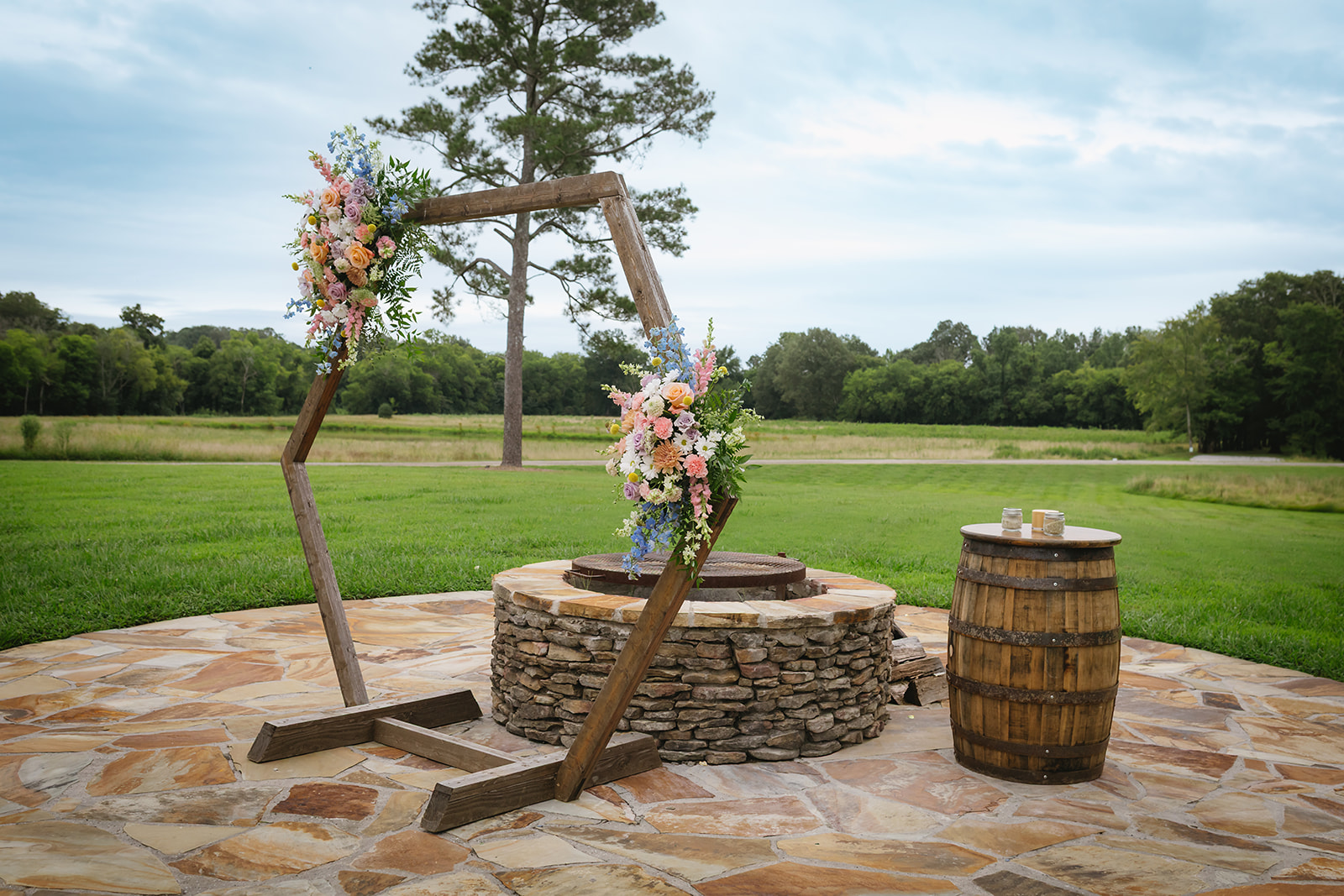 Floral hexagon arch and stone Firepit wait on the Patio for Meredith & Benjamin at Covey Creek
