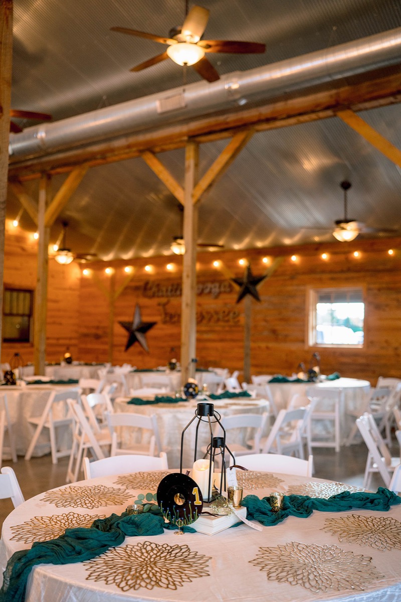 Peyton & Jackson's Covey Creek barn reception with round tables, teal runners, and a Chattanooga wall sign.