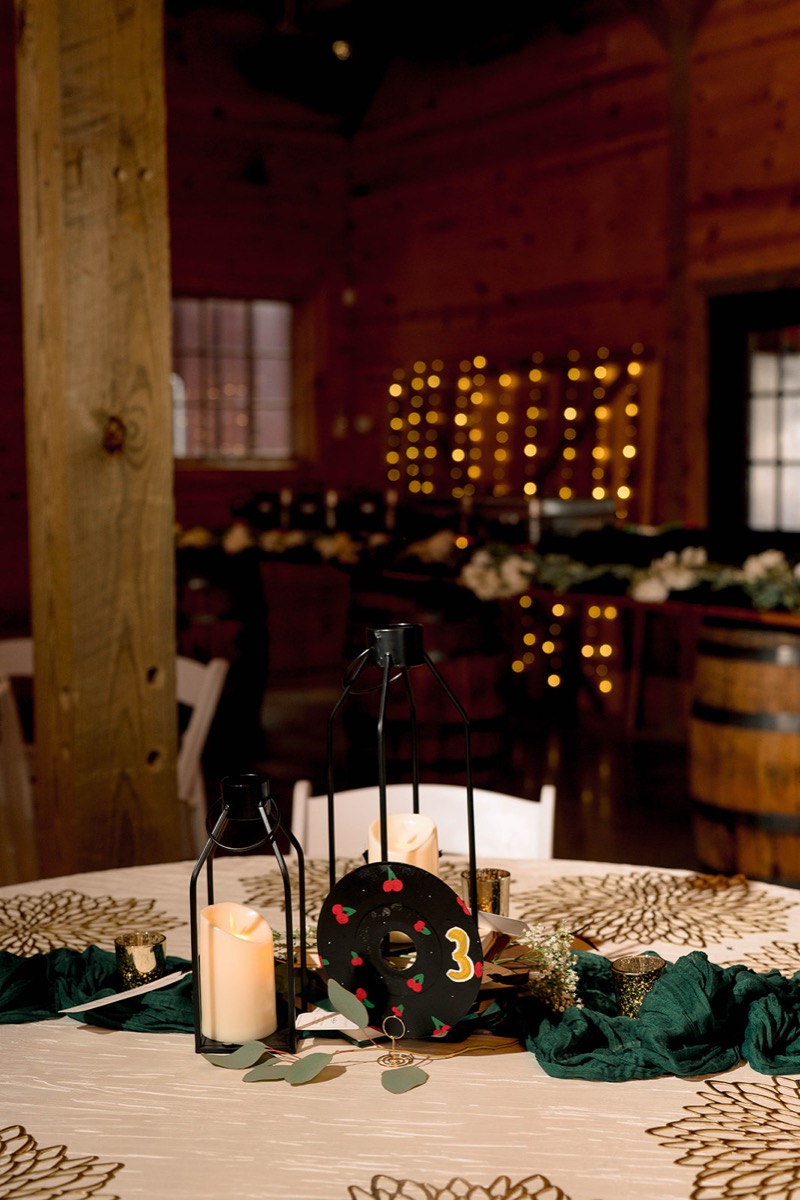 Vinyl-record table number 3 with black lanterns and eucalyptus on Peyton & Jackson's Covey Creek tablescape.