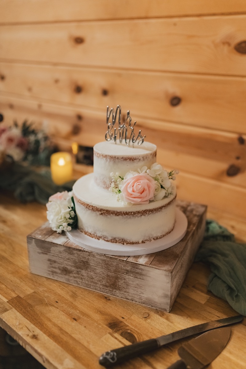 Semi-naked wedding cake with pink roses and Mr & Mrs topper for Rae & David at Covey Creek reception