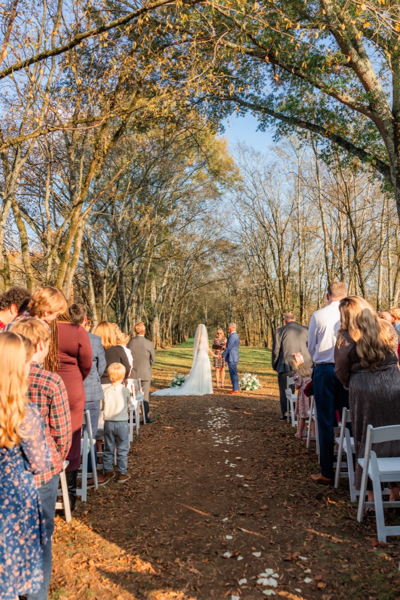 Sarah & Adam exchange vows under the Tunnel of Love tree canopy at their Covey Creek ceremony