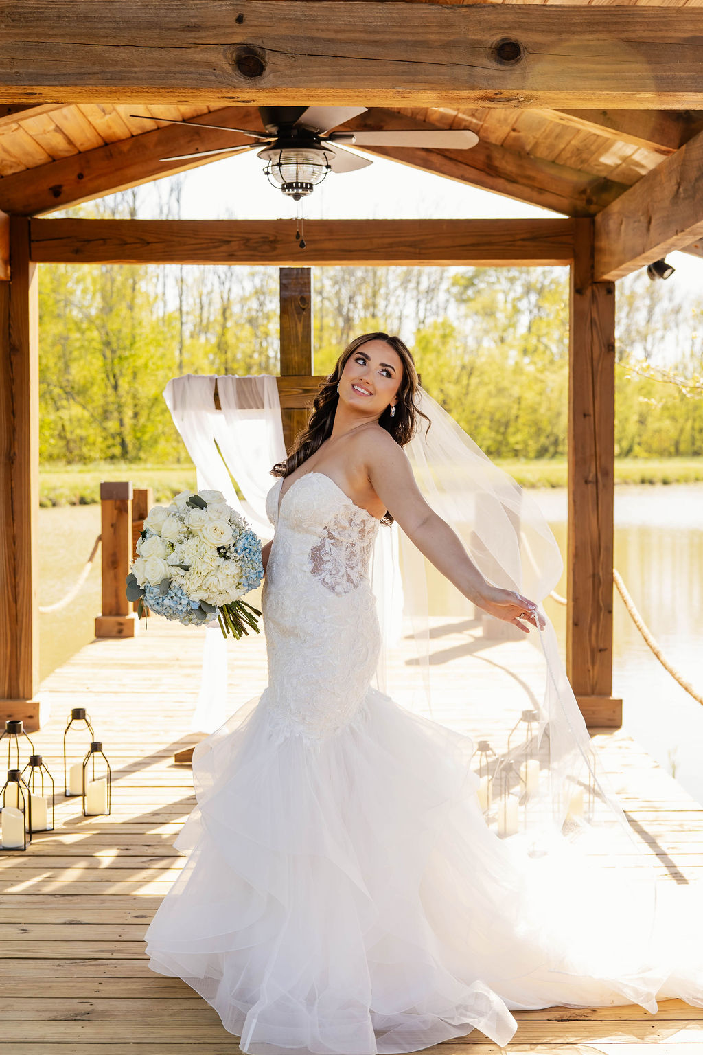 Shelbie & Callaway: bride Shelbie in a ruffled gown under the Pond pavilion with lanterns at Covey Creek