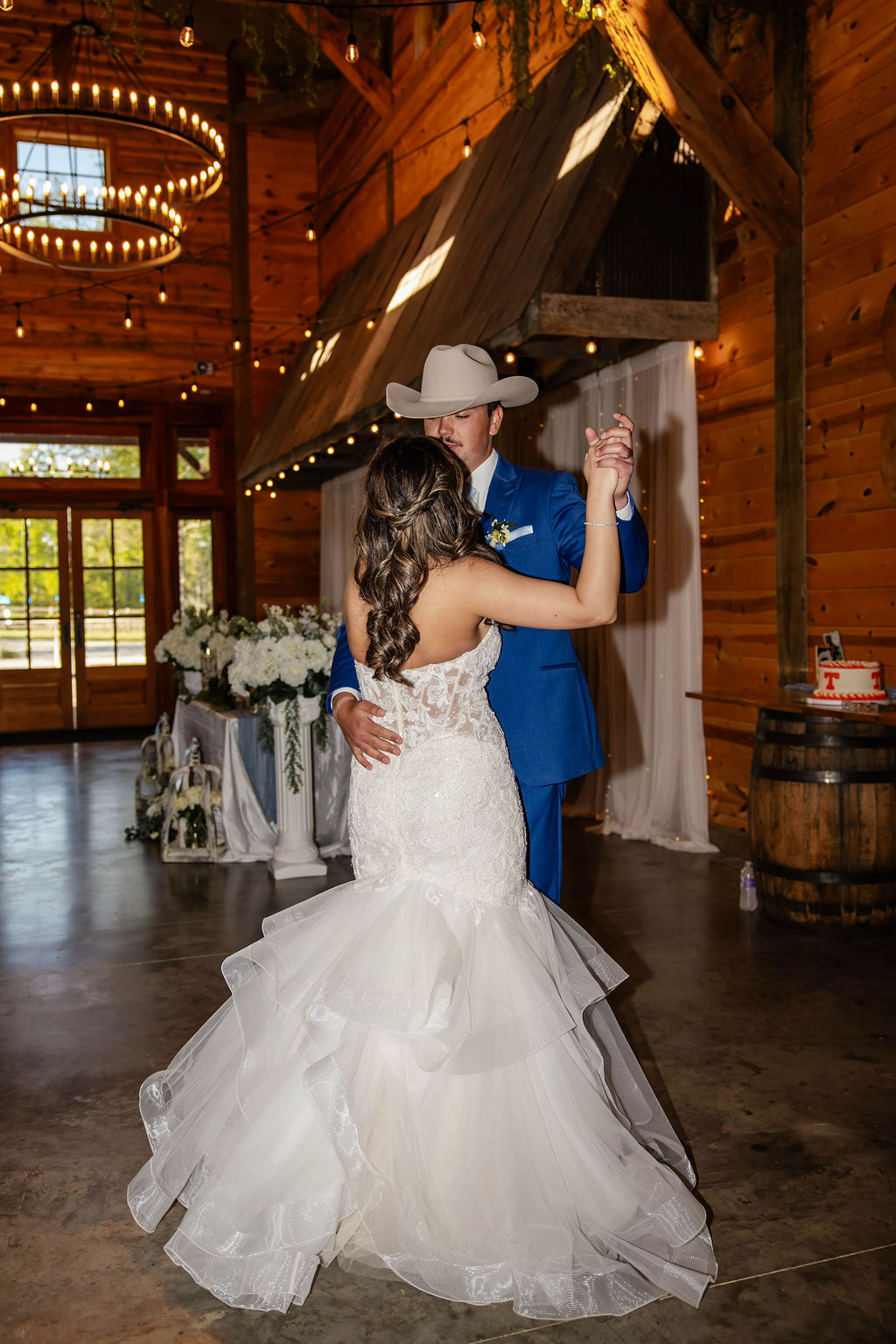 Shelbie & Callaway share their first dance under string lights in the Covey Creek indoor barn reception