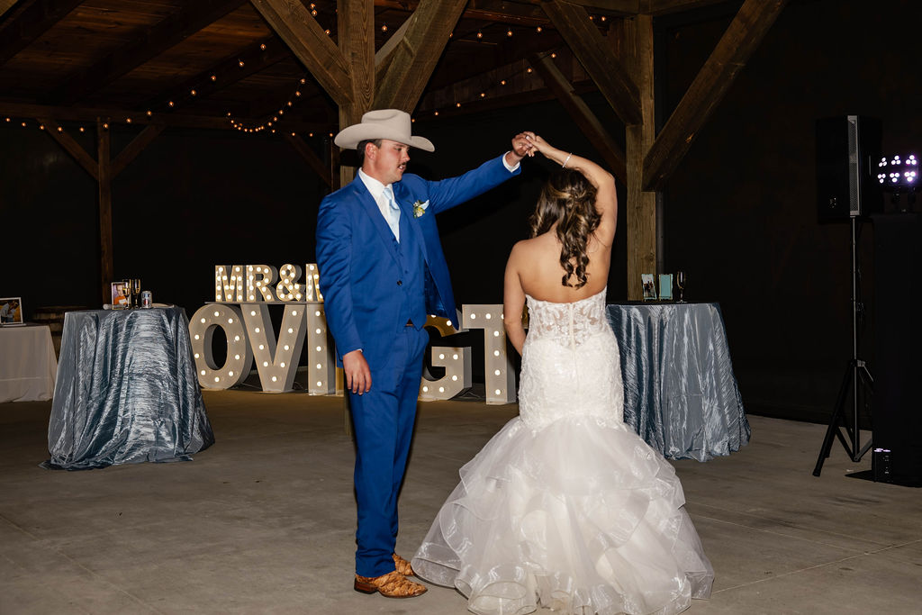 Shelbie & Callaway dance by lit MR & MRS COVINGTON marquee letters under string lights at Covey Creek