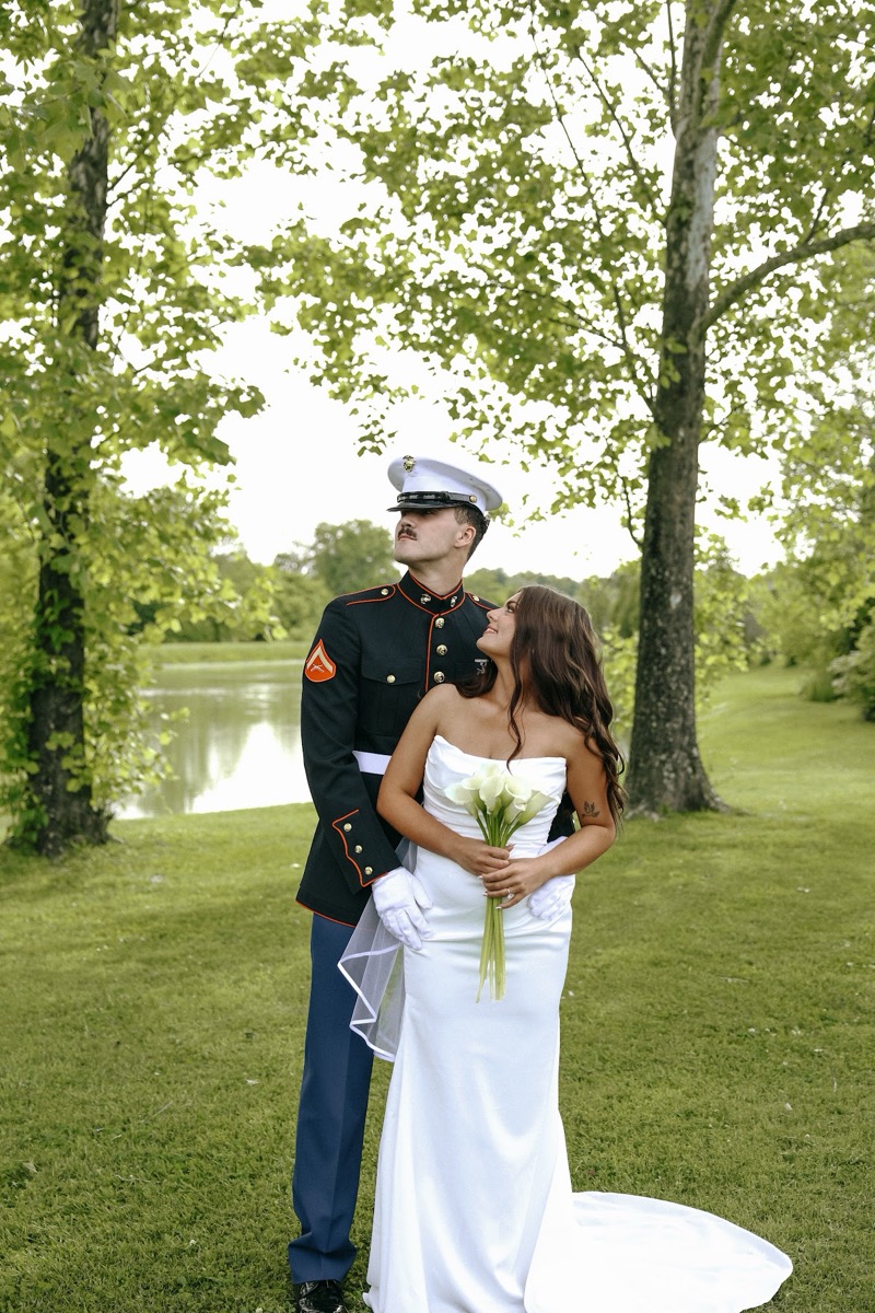 Cadence & Brody pose by the Pond, her calla lilies and his Marine dress blues against trees at Covey Creek