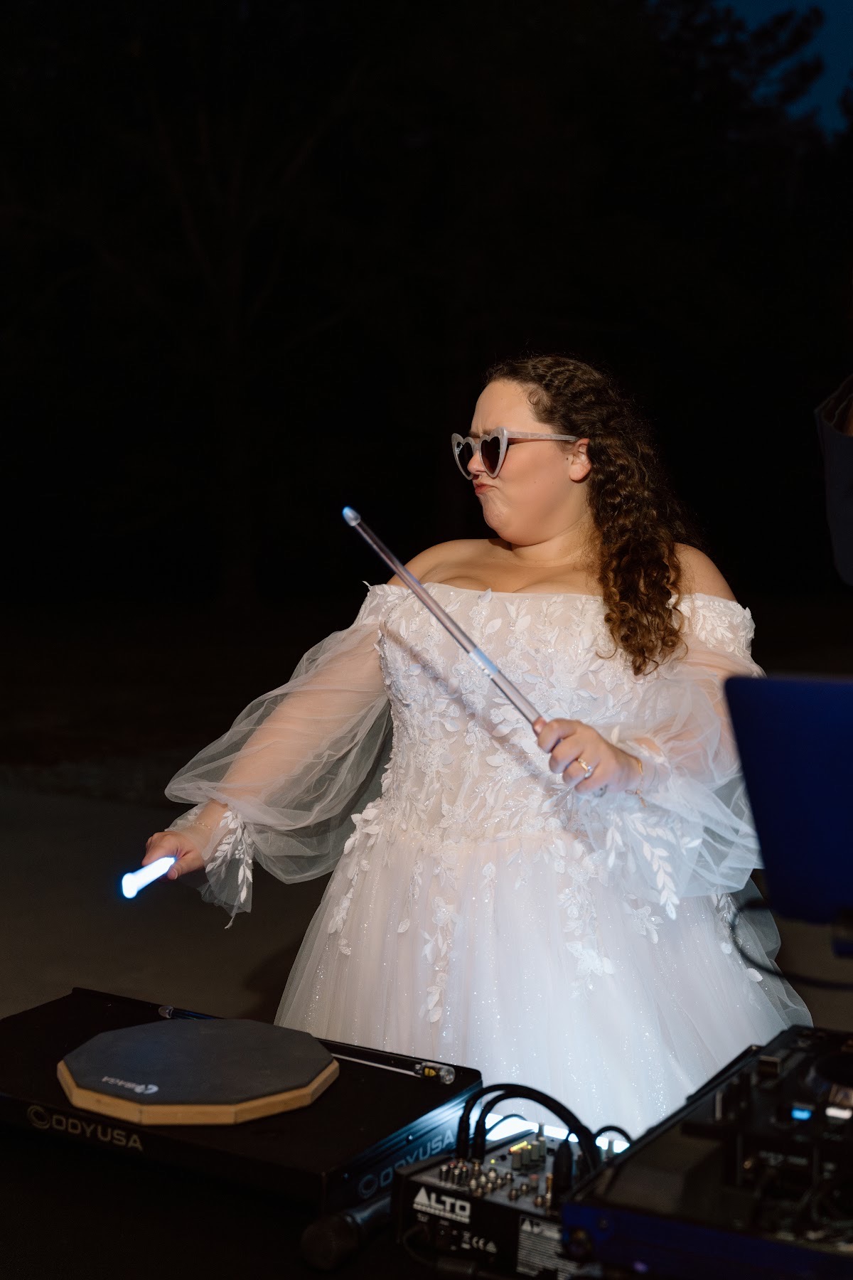 Katelynn plays glowing drumsticks in heart sunglasses behind the DJ booth at Covey Creek for Katelynn & Justin