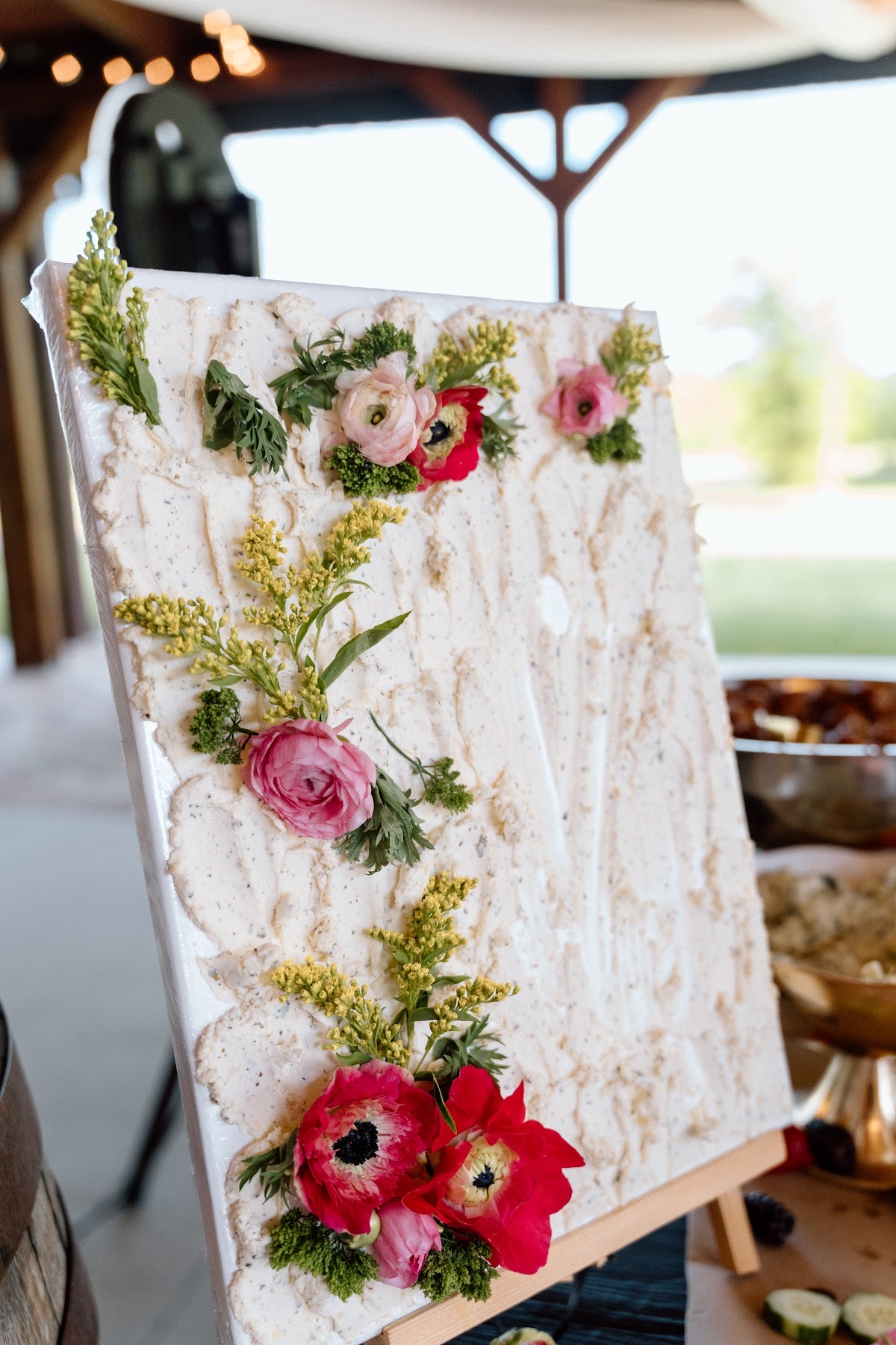 Herb butter board topped with pink and red blooms on the pavilion table for Stephanie & Josh at Covey Creek
