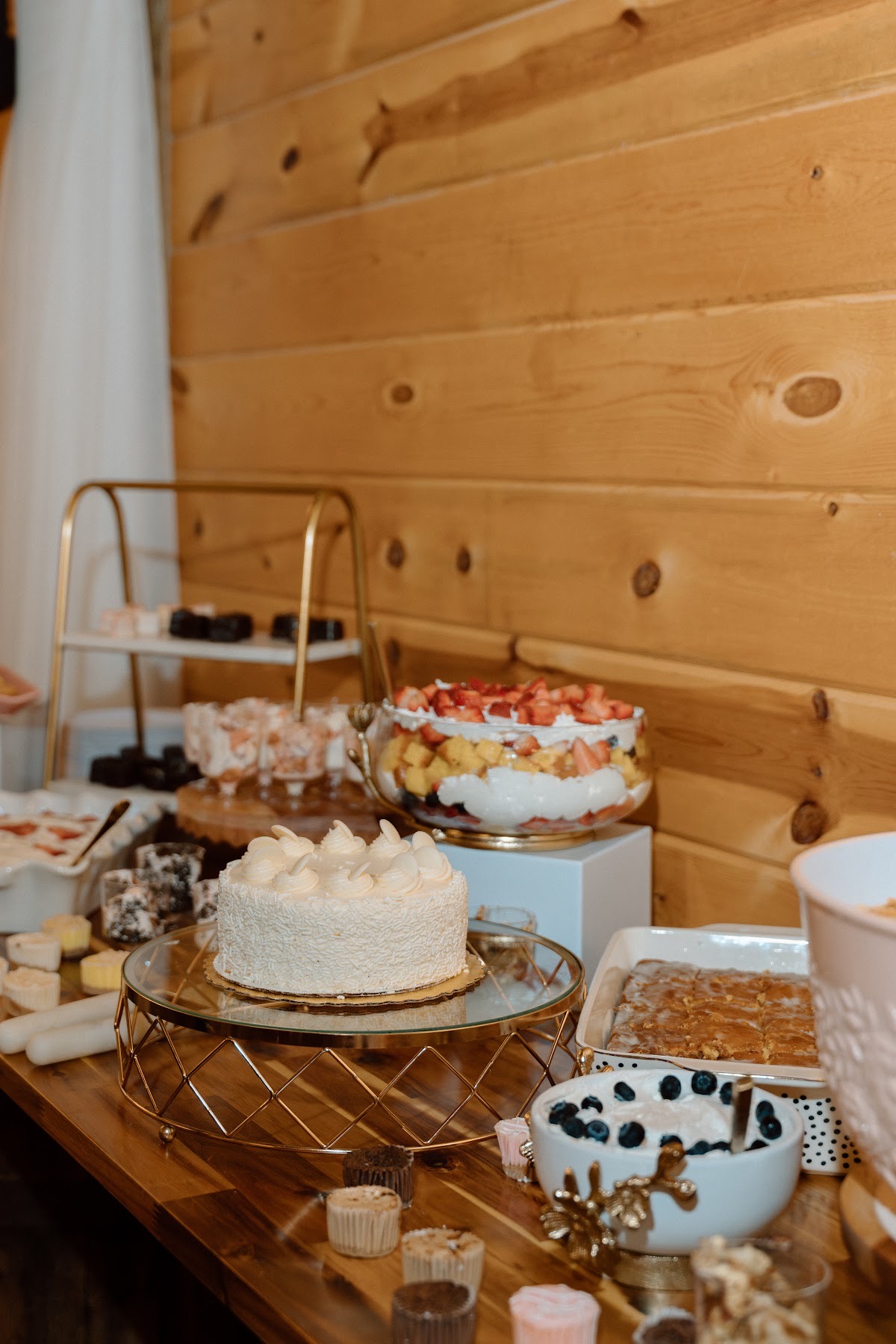 White cake, fruit trifle, and blueberry dessert on the sweets table for Stephanie & Josh at Covey Creek